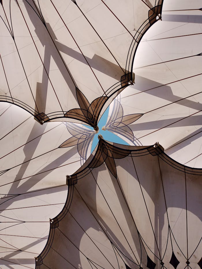 our-services-3 Intricate canopy and Islamic pattern design capturing sunlight and shadows in a vertical shot.