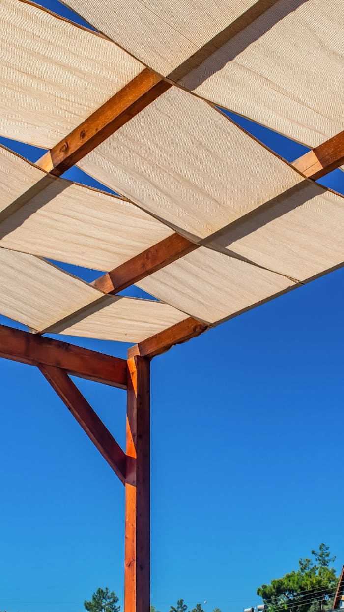 services-01 A wooden gazebo with a linen roof under a clear blue sky in Fethiye, Türkiye.
