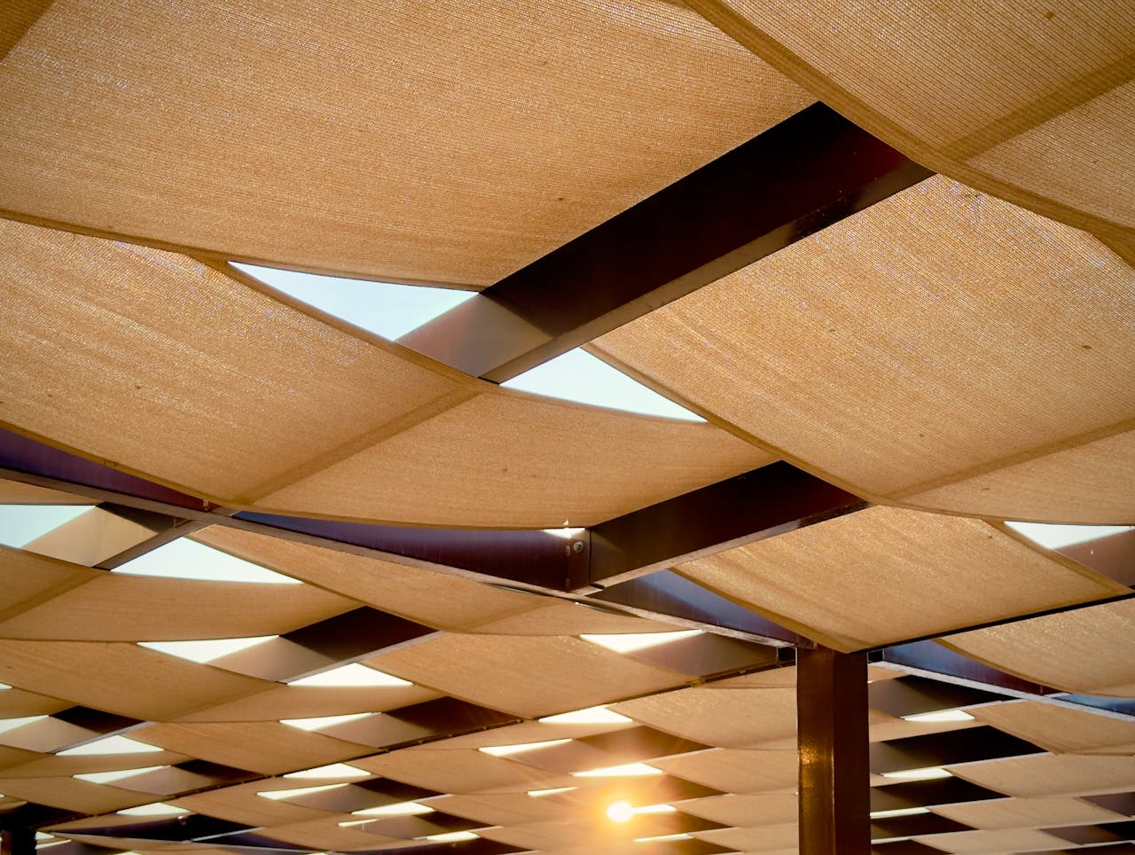 our-services-2 Abstract view of a modern architectural canopy with sun rays in Dubai.